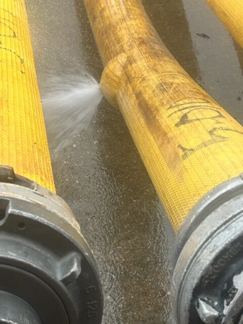 A close up of two pipes with yellow paint on them.